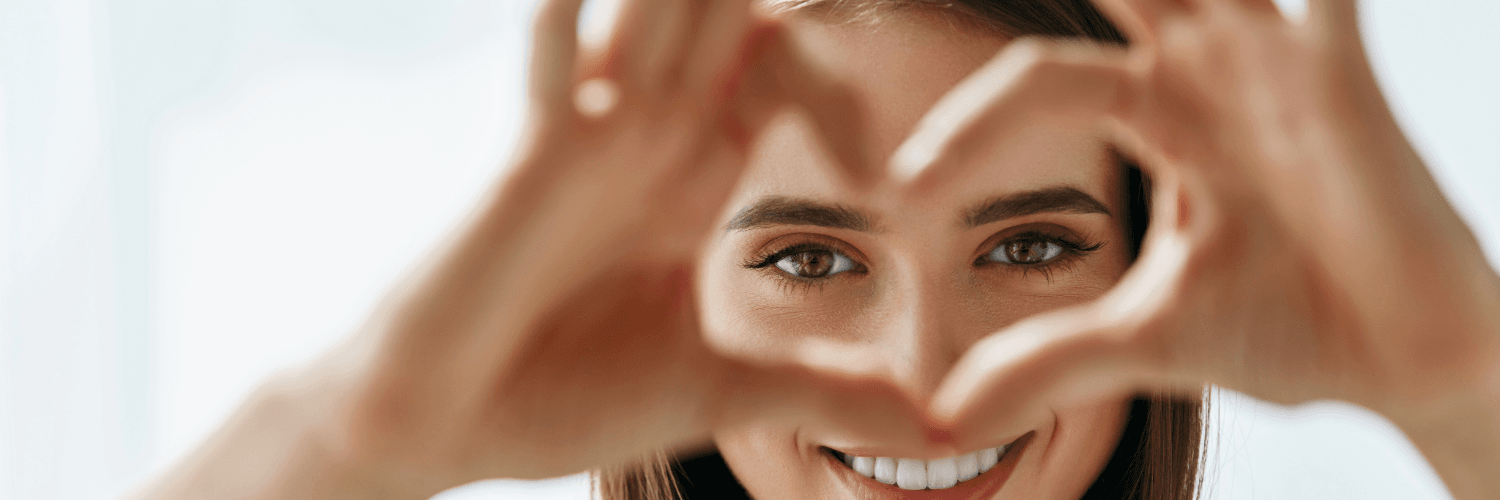 girl heart sign in front of eyes